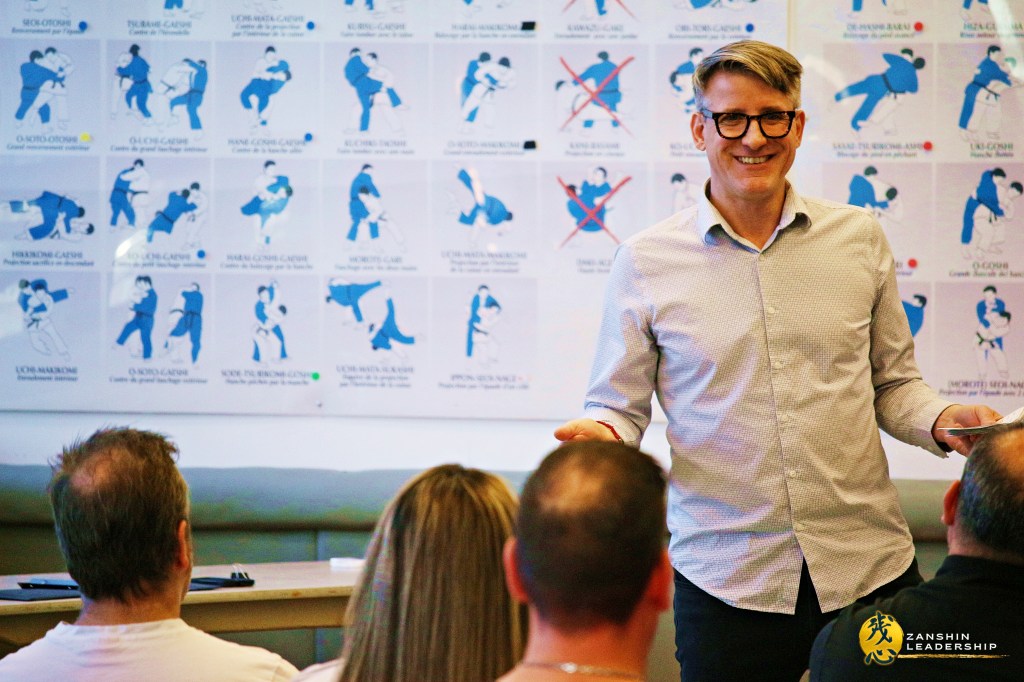 Matthaeus Bauernberger discussing the importance of leadership resilience, inspired by "Kokoro" (heart/mind/spirit), at a Zanshin Leadership seminar.